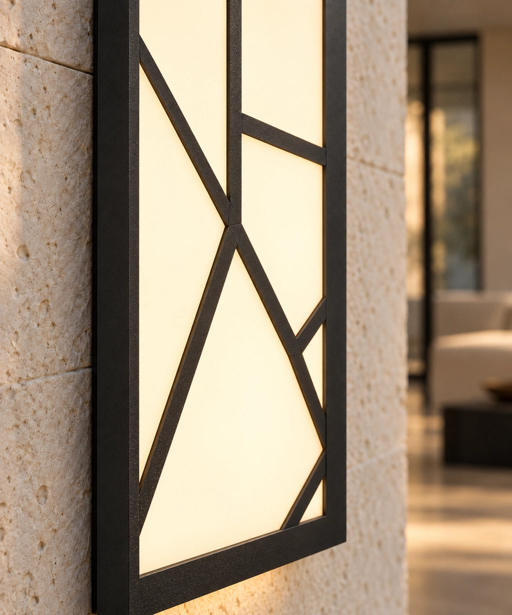 Détail du motif noir devant le panneau lumineux, applique installée sur un mur en pierre