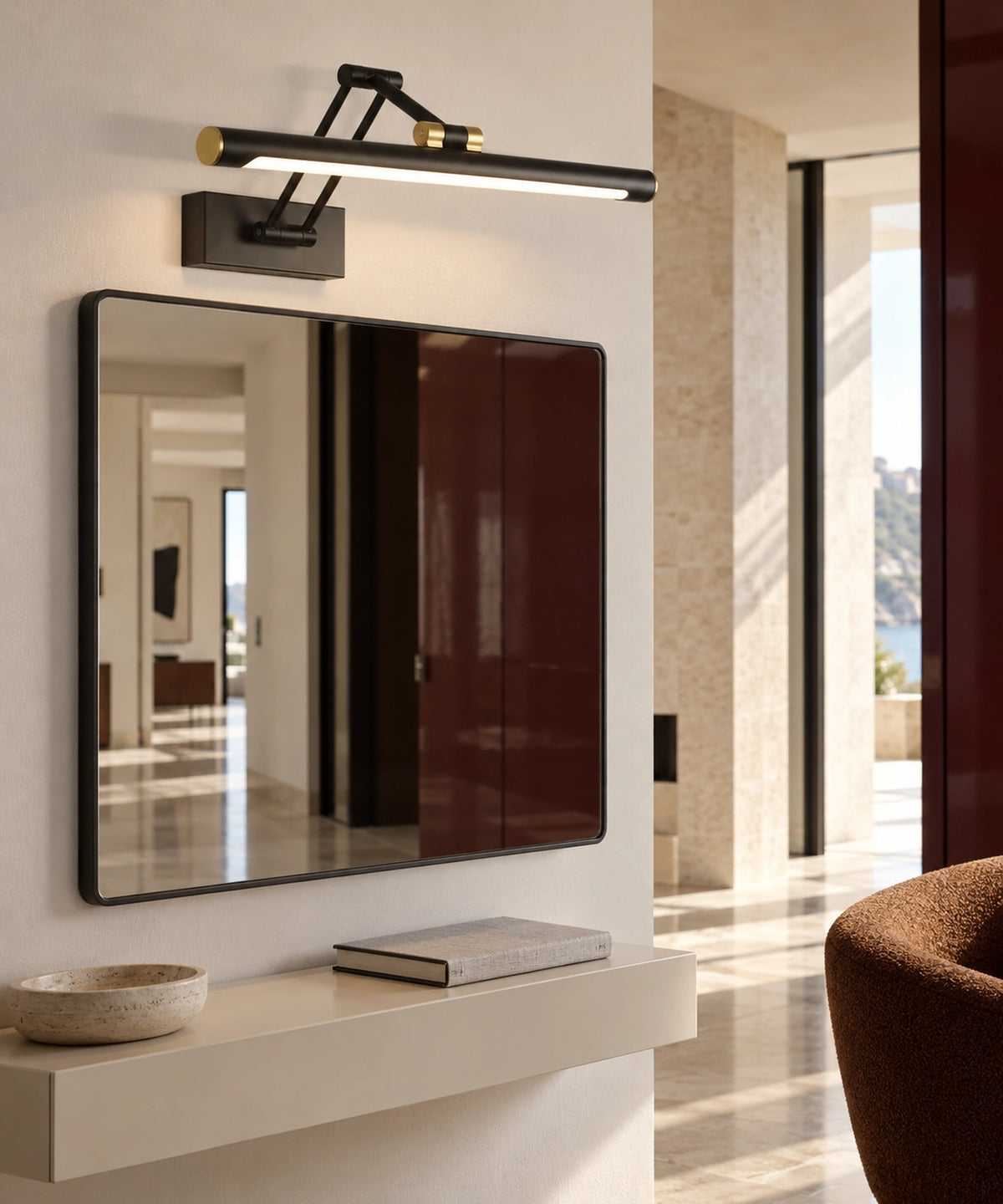 Applique articulée noire vue de côté au-dessus d’un miroir et d’une console d’entrée