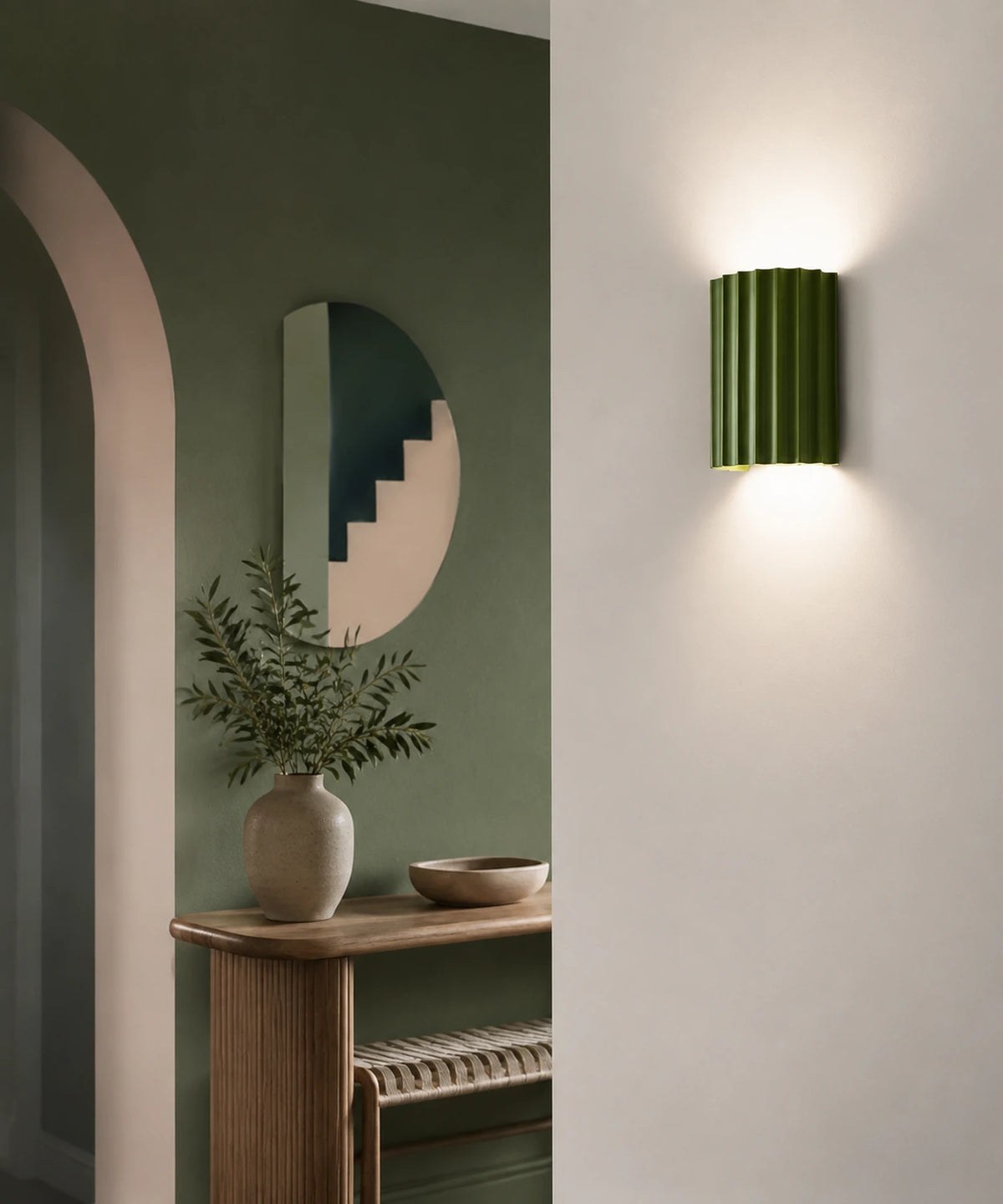 Applique cannelée verte allumée sur un mur clair près d’une console Image