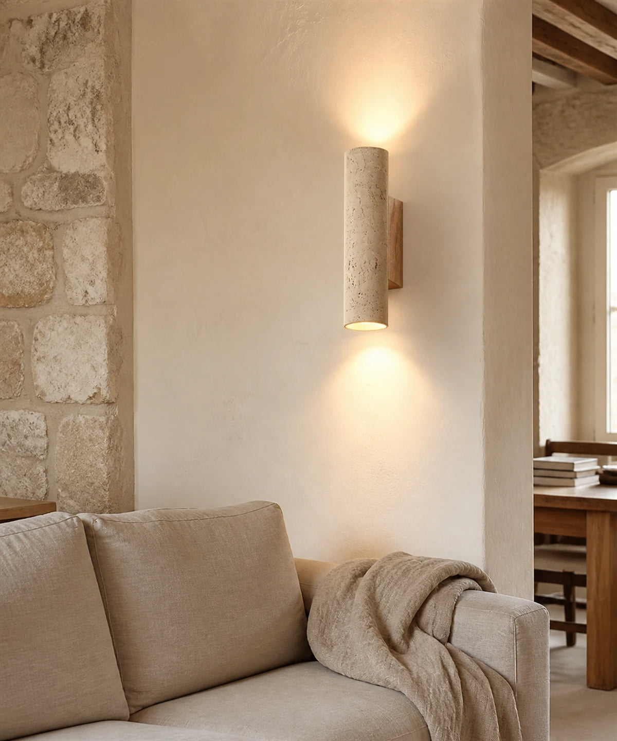 Applique murale en travertin et bois, finition bois clair, allumée dans un salon