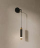 Applique murale tube suspendu, tube noir à bagues dorées sur mur en enduit