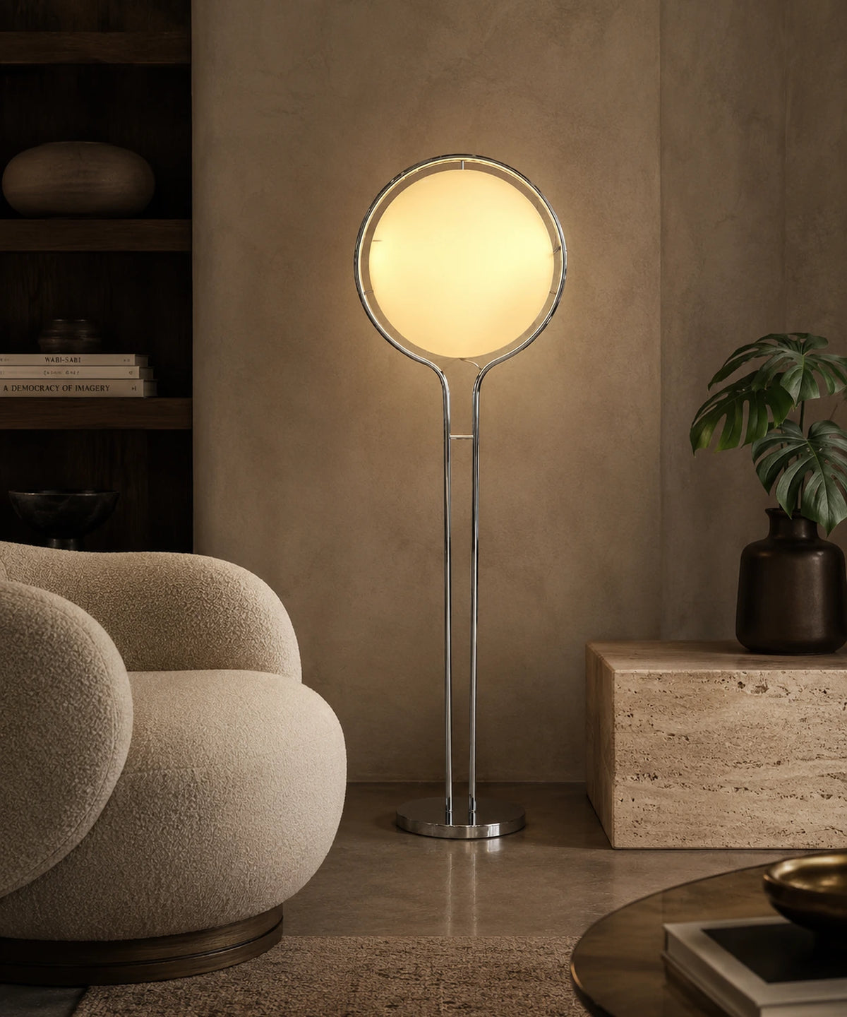 Lampadaire boule opaline jaune allumé derrière un fauteuil en bouclette, plante verte