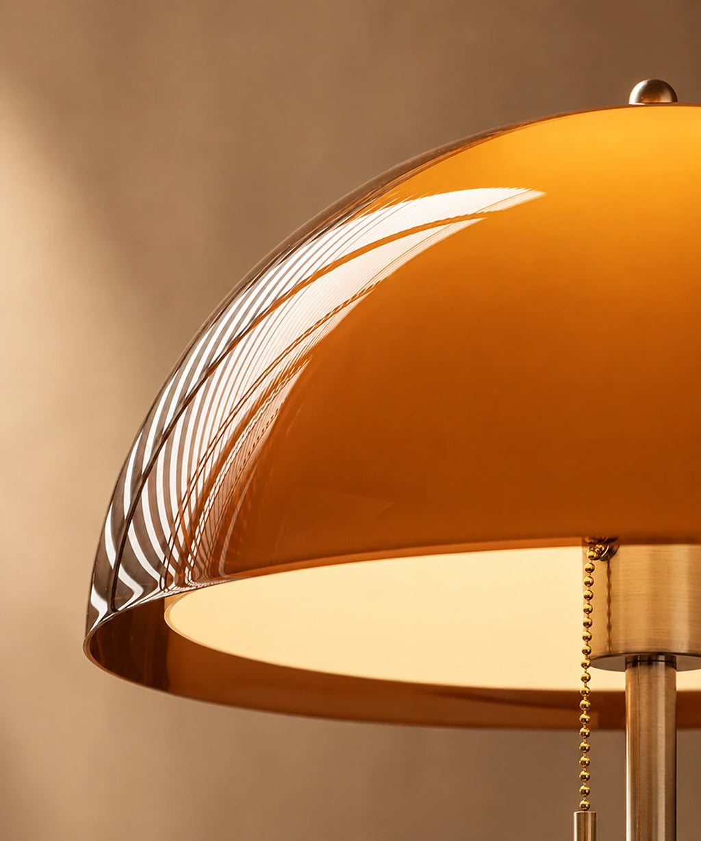 Détail du dôme ambré allumé et de la chaînette à tirer du lampadaire champignon