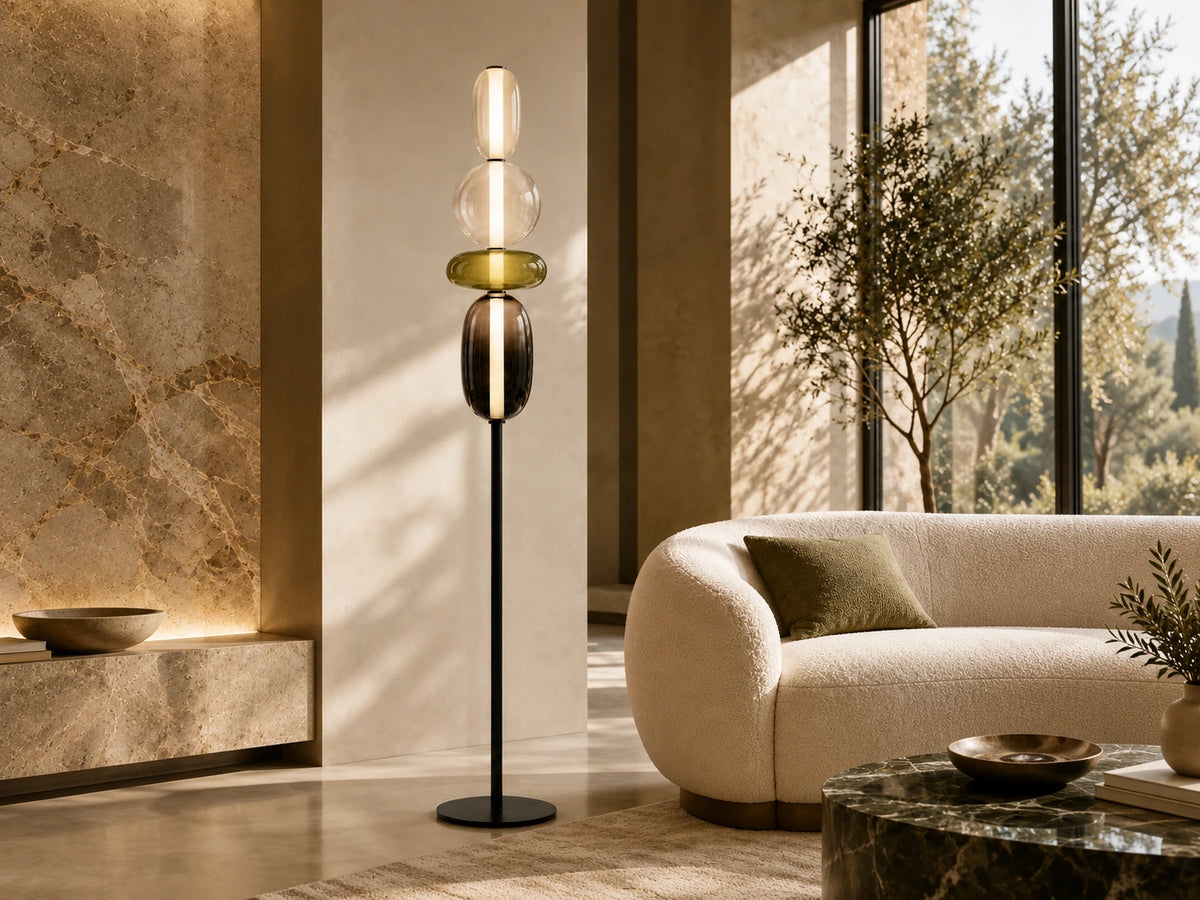 Lampadaire à quatre globes en verre coloré et socle noir, près d’une assise crème Image