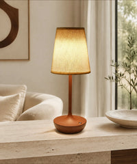 Lampe de table sans fil marron à abat-jour en tissu, posée près d’un canapé