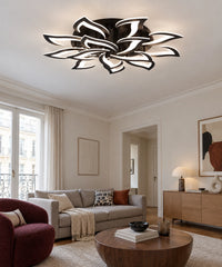 Plafonnier lotus noir allumé dans un salon avec canapé beige et fauteuil bordeaux