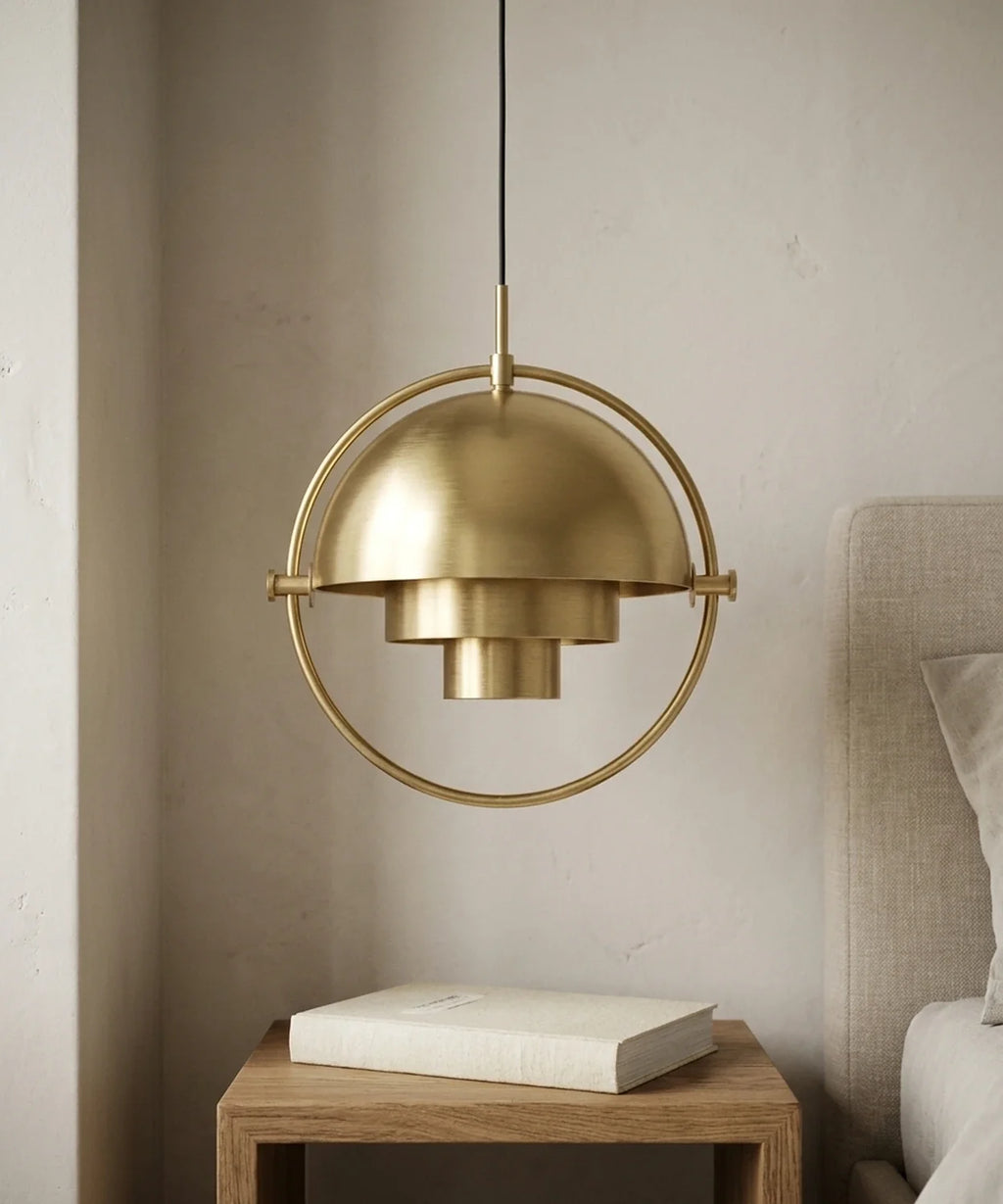 Suspension demi sphere orientable laiton allumee au-dessus d une table de chevet