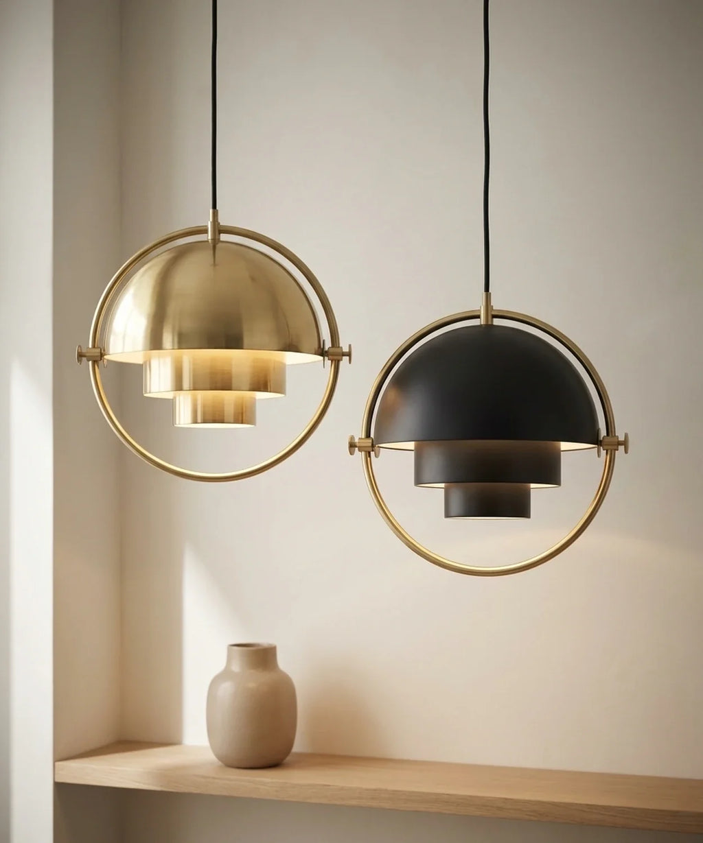 Deux suspensions demi sphere orientable, une laiton et une noire, allumees cote a cote