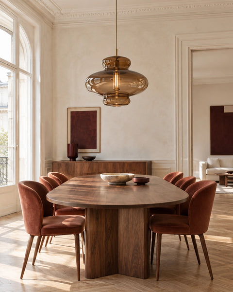 Suspension en verre ambré au-dessus d’une table en noyer, dans une salle à manger lumineuse
